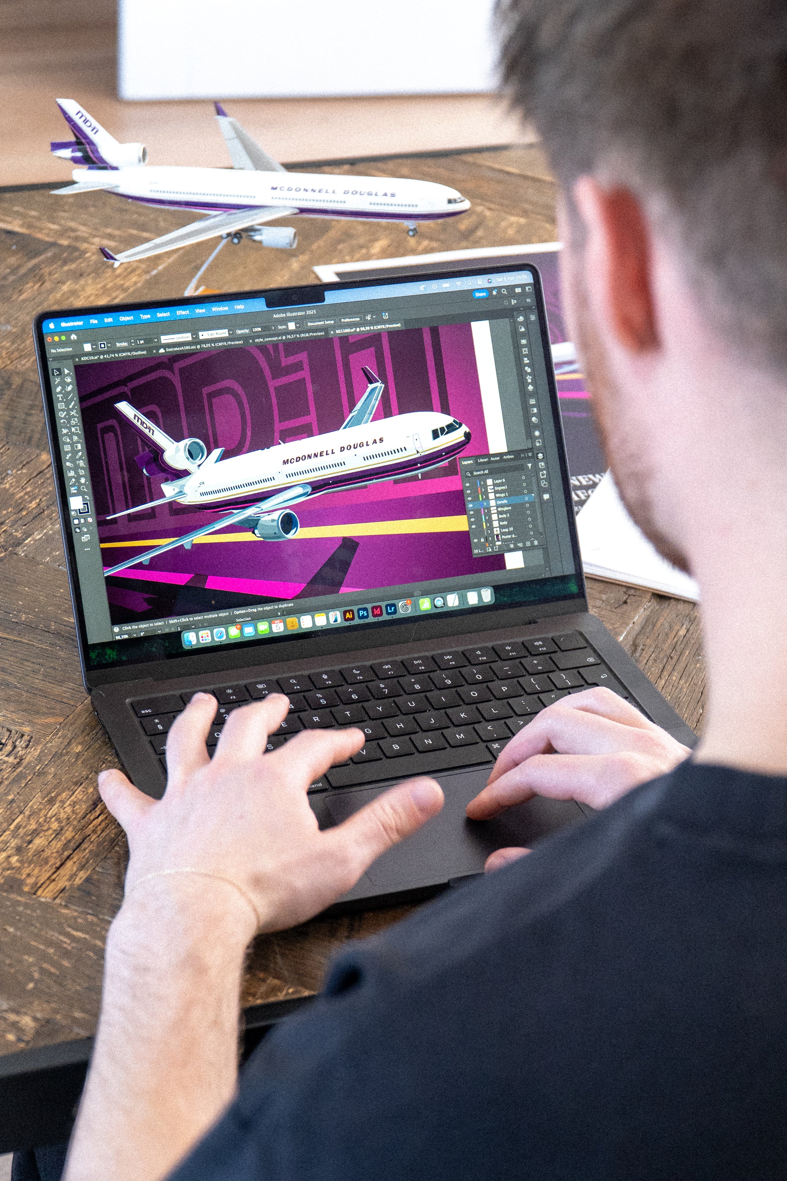 Over-the-shoulder view of Njord working on the Studio11 N211MD MD-11 prototype illustration, with the artwork in progress on the screen.